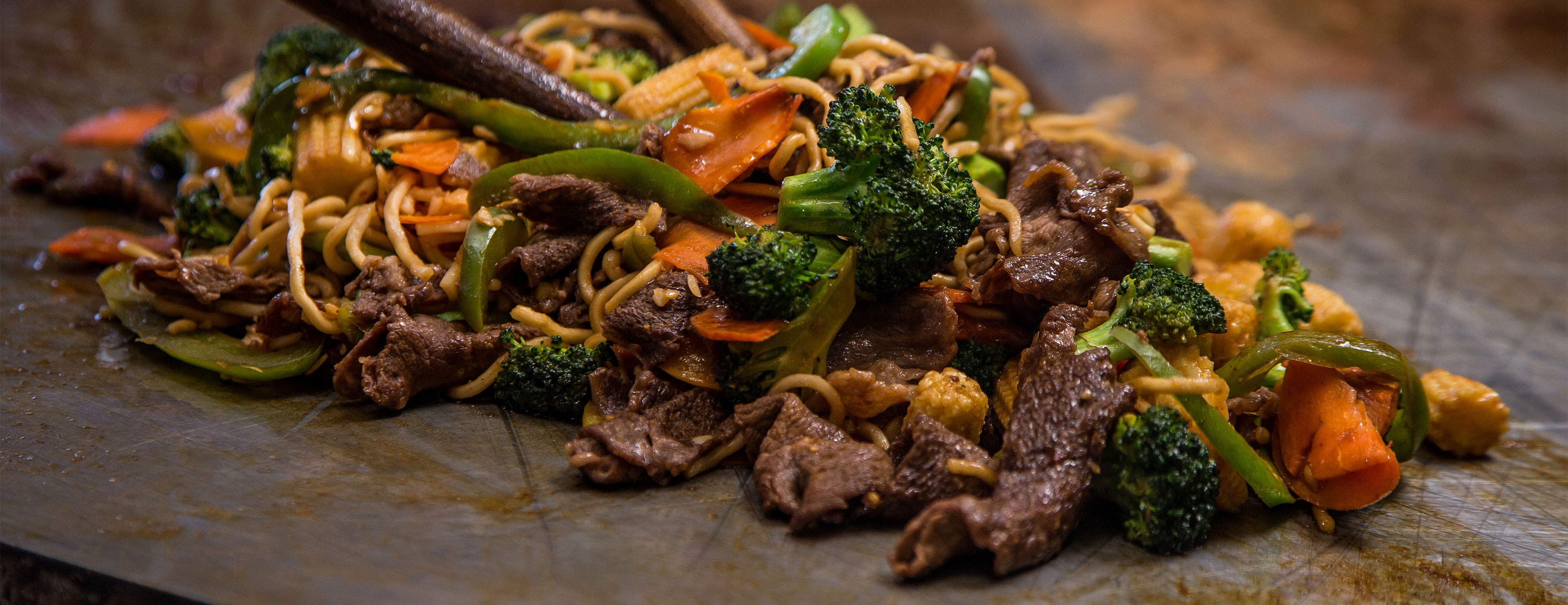 Noodles, veggies, and beef on the grill